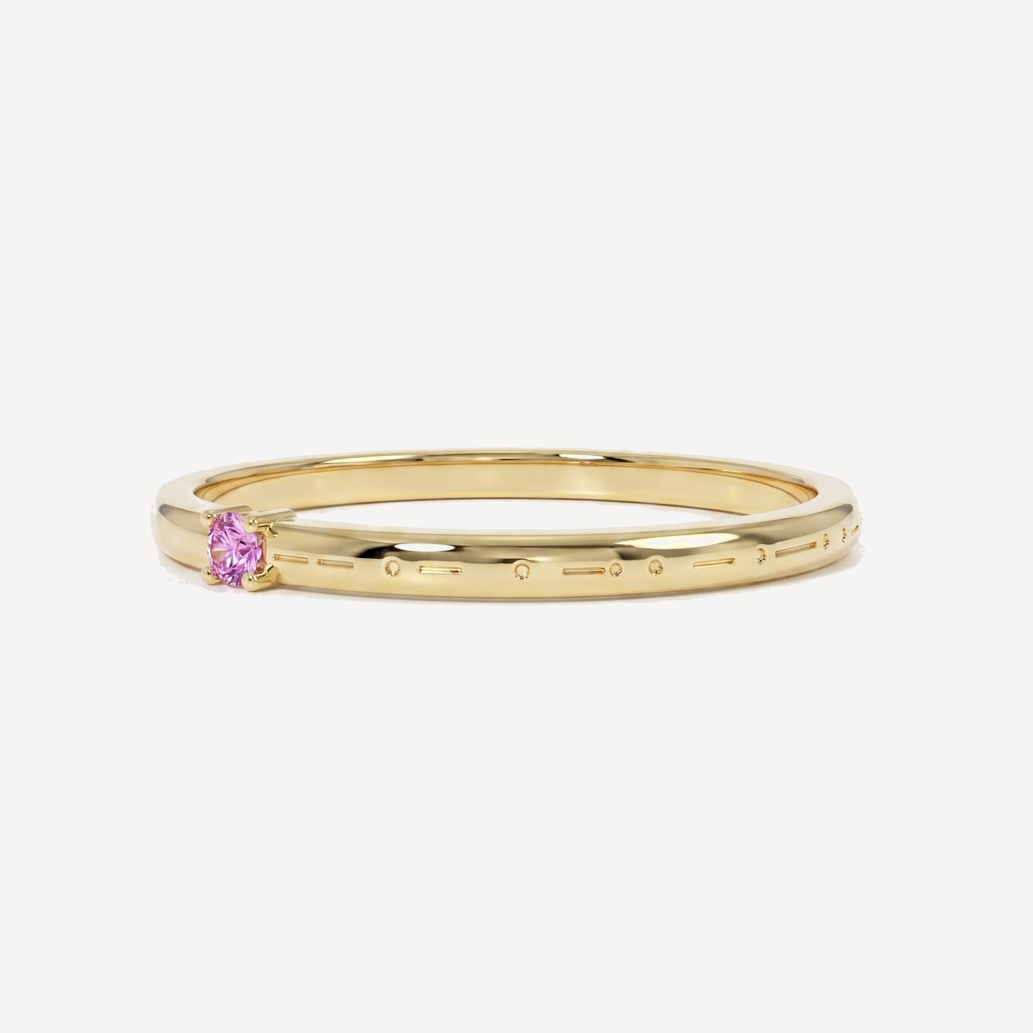Custom engraved Morse code single birthstone ring in polished yellow gold with a pink birthstone and personalised Morse code engraving