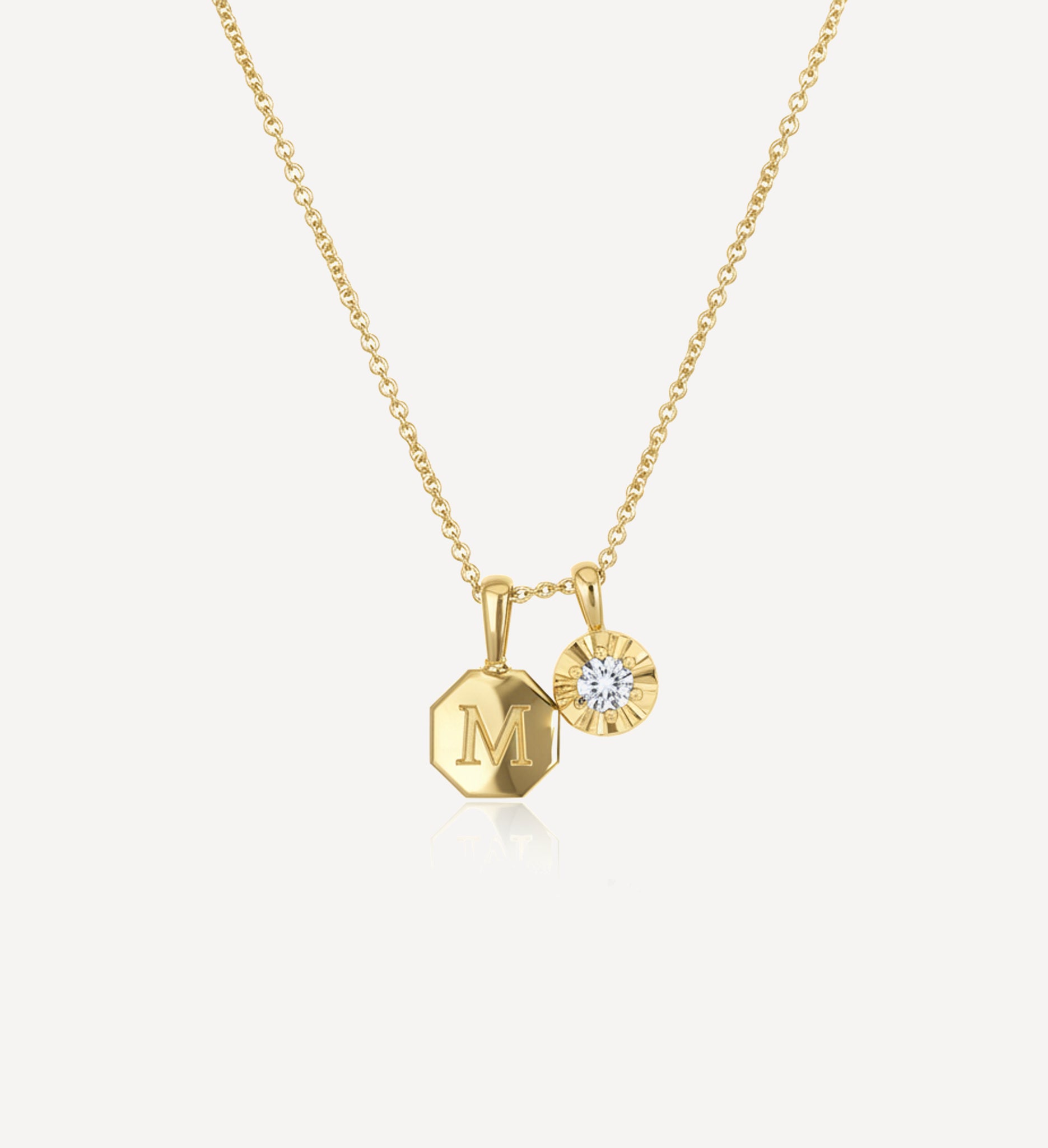 Keepsake charm necklace HLSK octagon medium in yellow gold featuring a personalised octagon initial charm engraved with the letter M and a diamond charm suspended from a fine gold chain