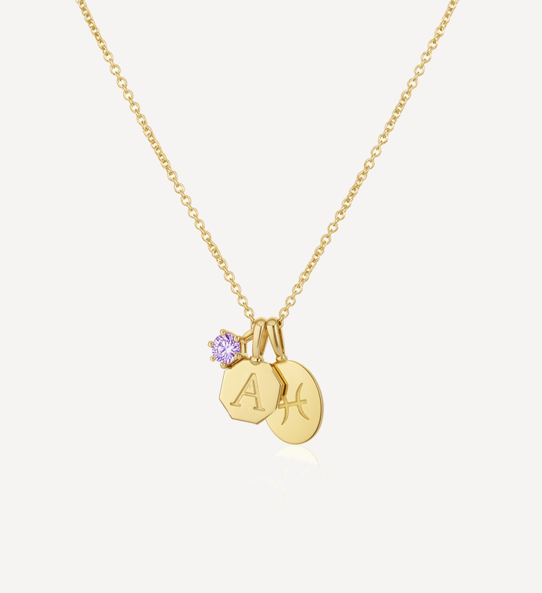 Handcrafted keepsake charm necklace in yellow gold featuring a personalised initial charm, zodiac charm and purple birthstone charm suspended from a fine gold chain
