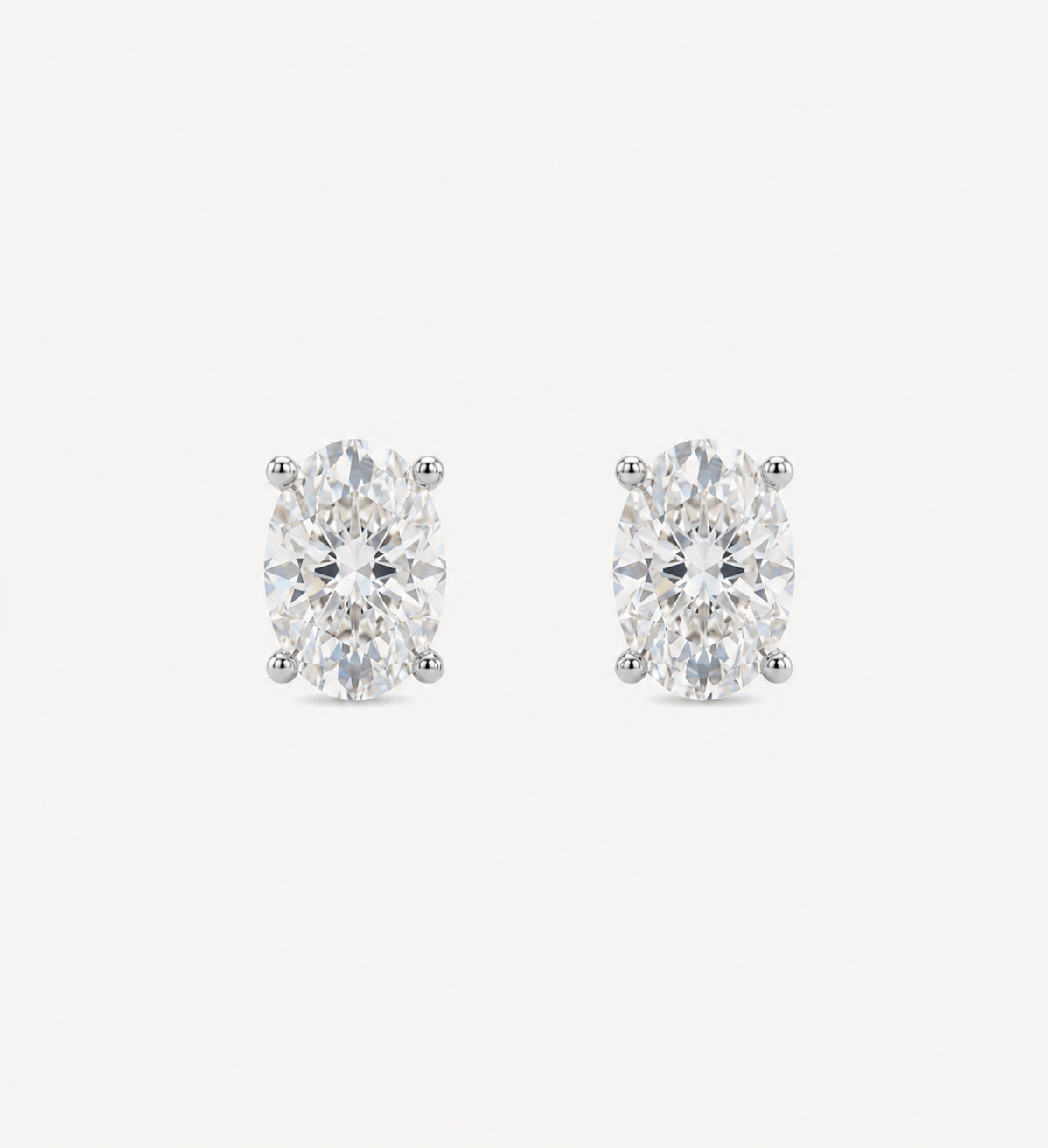 Large Oval Grace diamond stud earrings in white gold featuring oval brilliant-cut diamonds, shown in front and side profile with a four-prong setting and butterfly back