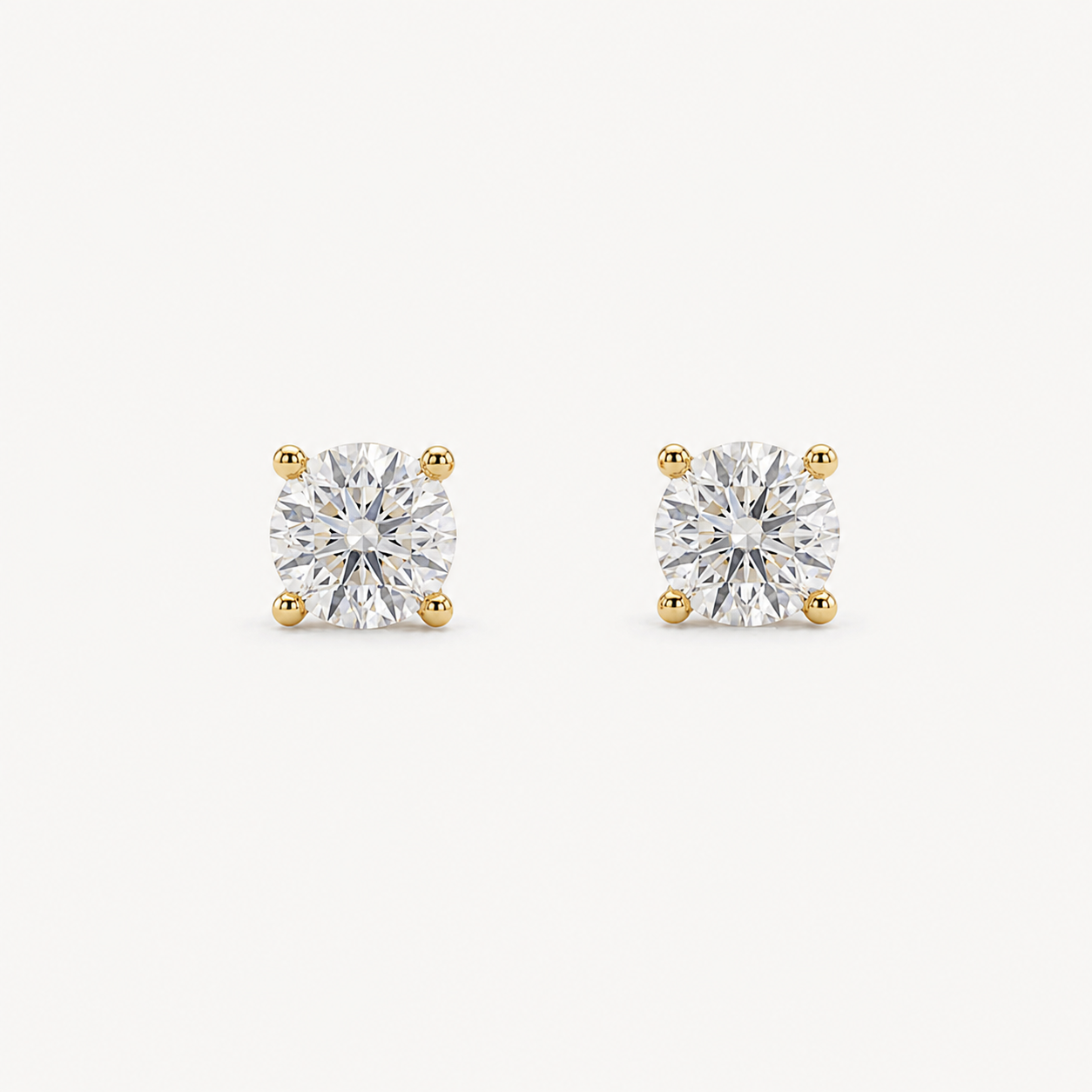 Medium Grace round brilliant-cut diamond stud earrings in yellow gold four-prong settings