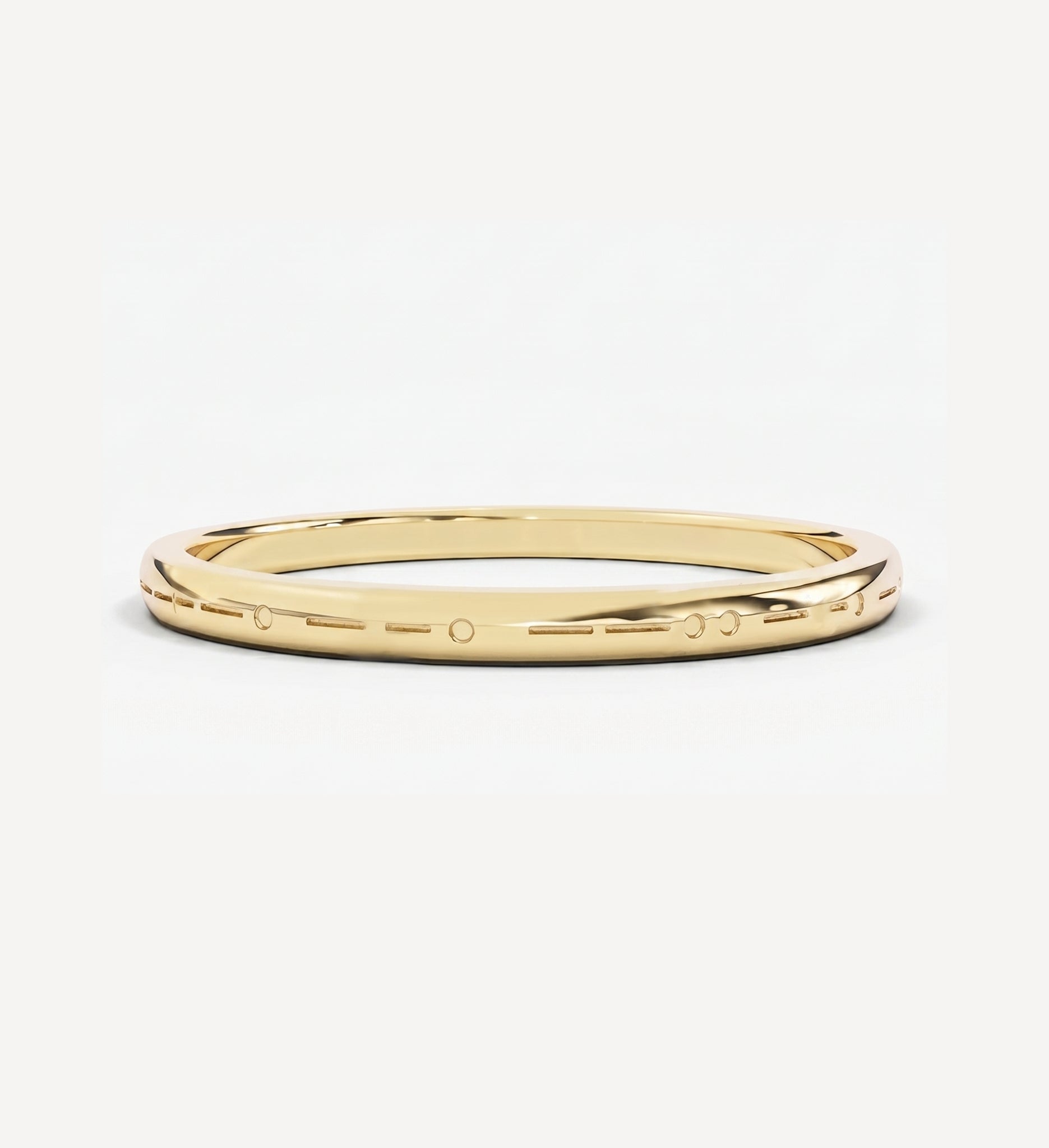 Plain engraved custom Morse code ring in polished yellow gold featuring personalised dot and dash engraving around the band