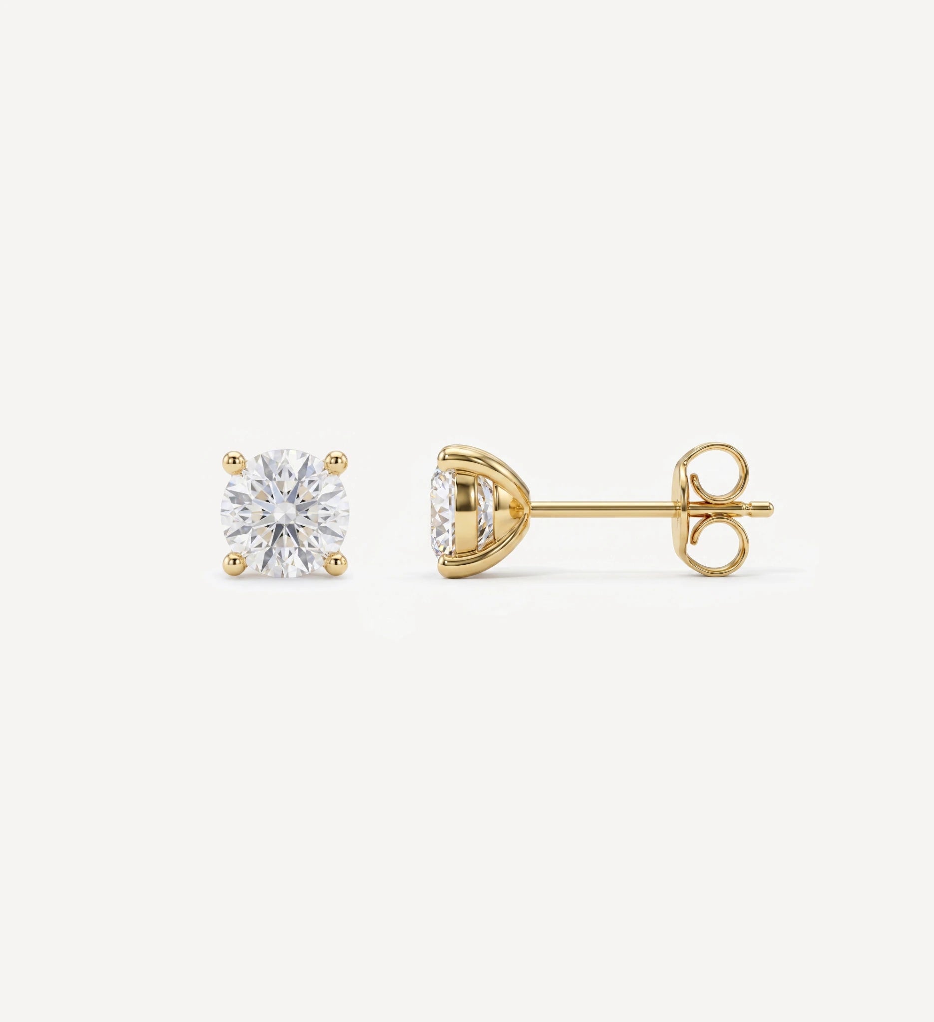 Medium Grace round brilliant-cut diamond stud earrings in yellow gold four-prong settings
