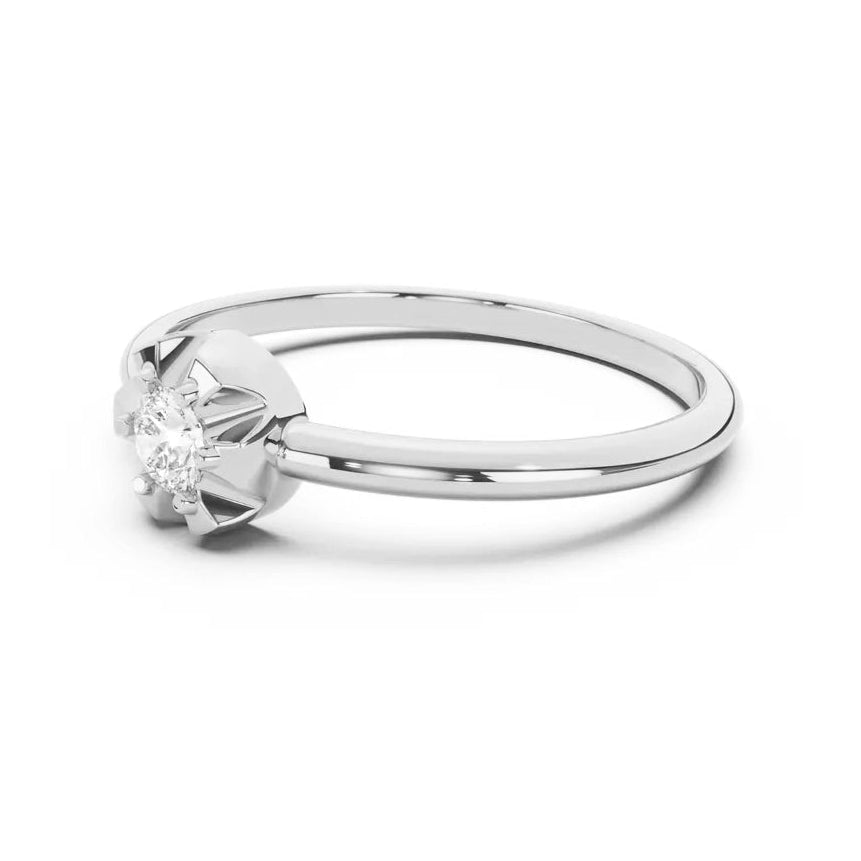 Silver scallop ring with a diamond on a white background