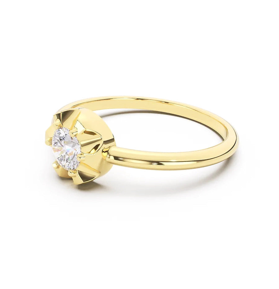 Gold scallop ring with a diamond on a white background