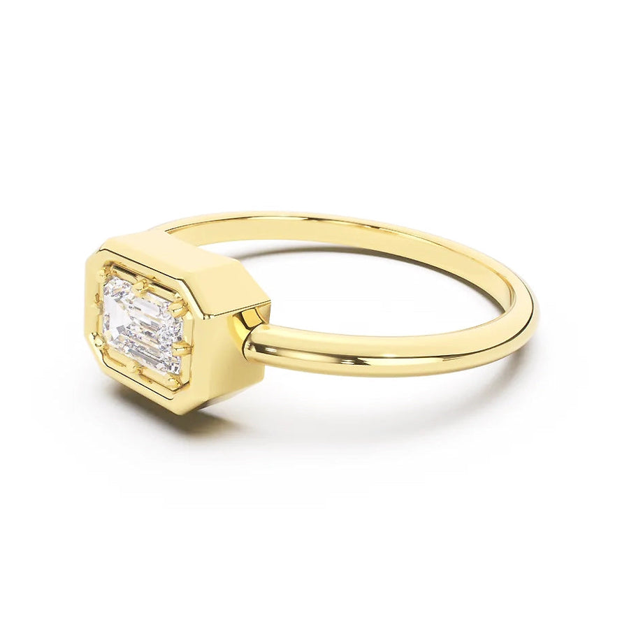 Gold ring with a diamond on a white background