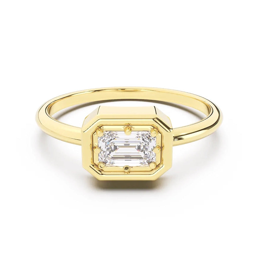 Gold ring with a diamond on a white background
