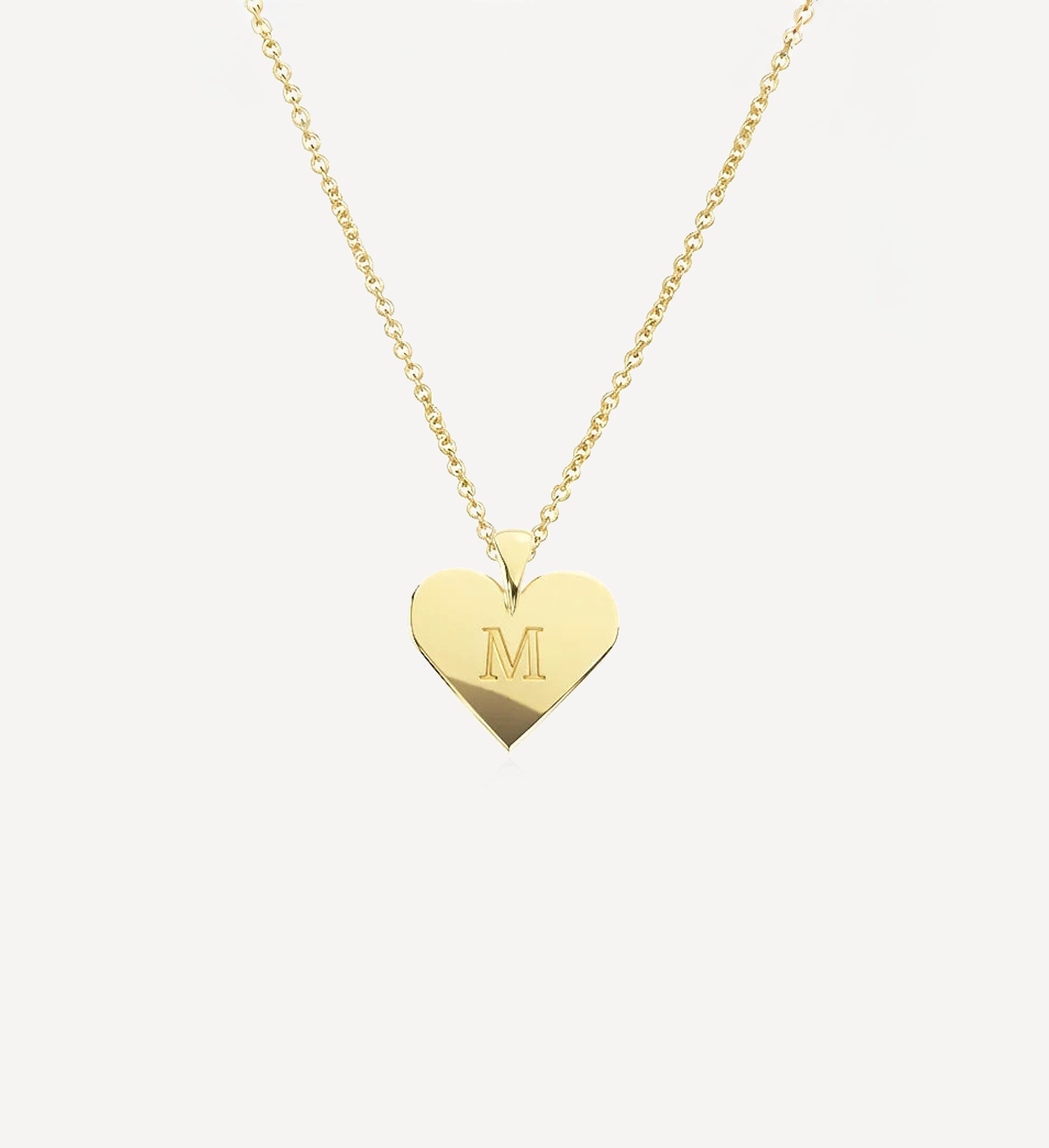 Engraved solid gold heart initial necklace in yellow gold featuring a personalised heart pendant with engraved initial on a delicate chain