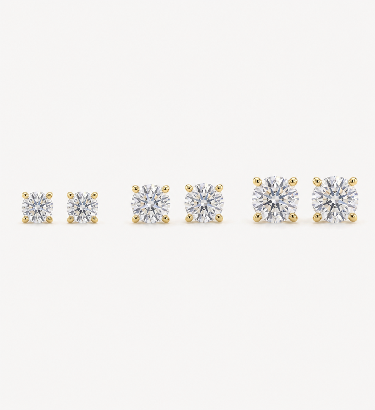 small to large comparison Grace round brilliant-cut diamond stud earrings in yellow gold four-prong settings