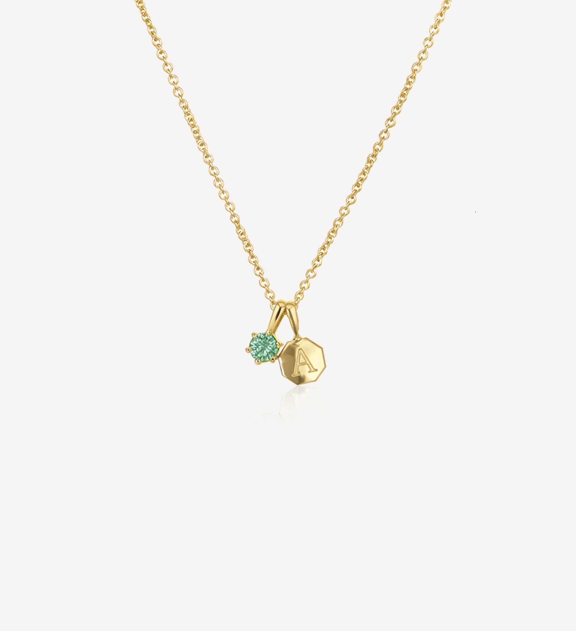Keepsake charm necklace HLSK octogon petite in yellow gold featuring a personalised octagon initial charm and green birthstone charm