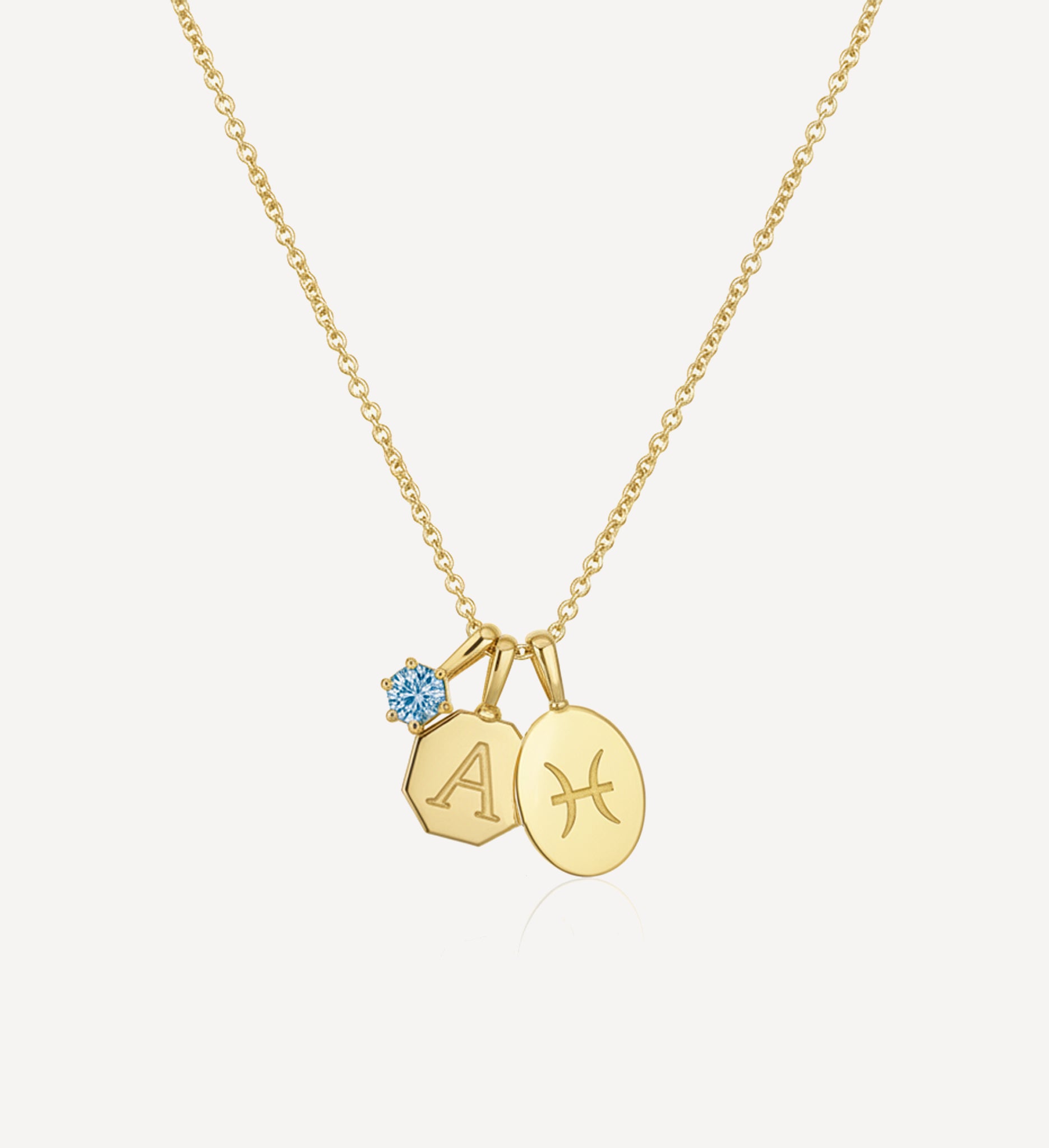 Handcrafted keepsake charm necklace in yellow gold featuring a personalised initial charm, zodiac charm and purple birthstone charm suspended from a fine gold chain