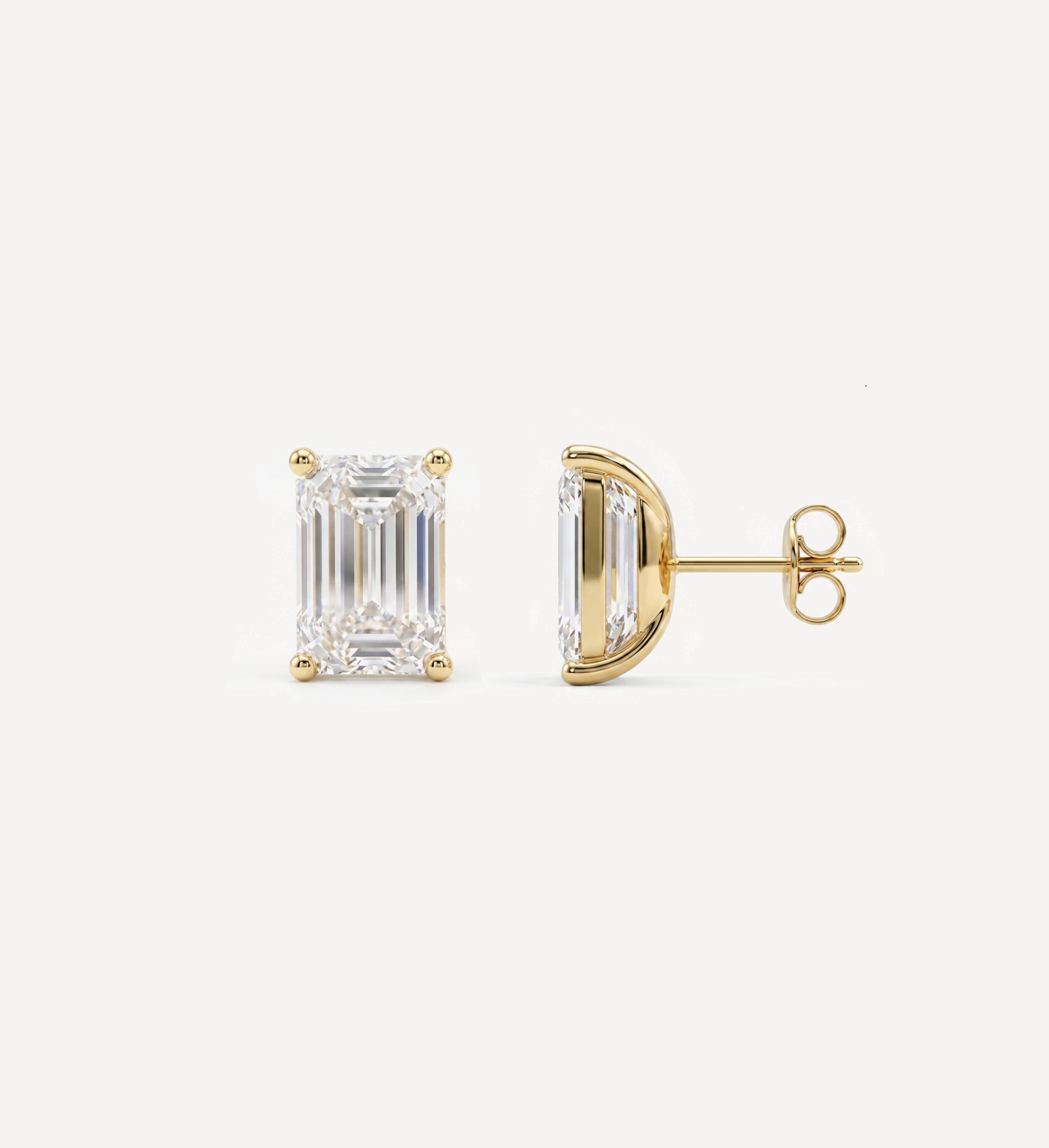 Large Emerald Grace diamond stud earrings in yellow gold featuring an emerald-cut diamond, shown in front and side profile with a four-prong setting and butterfly back