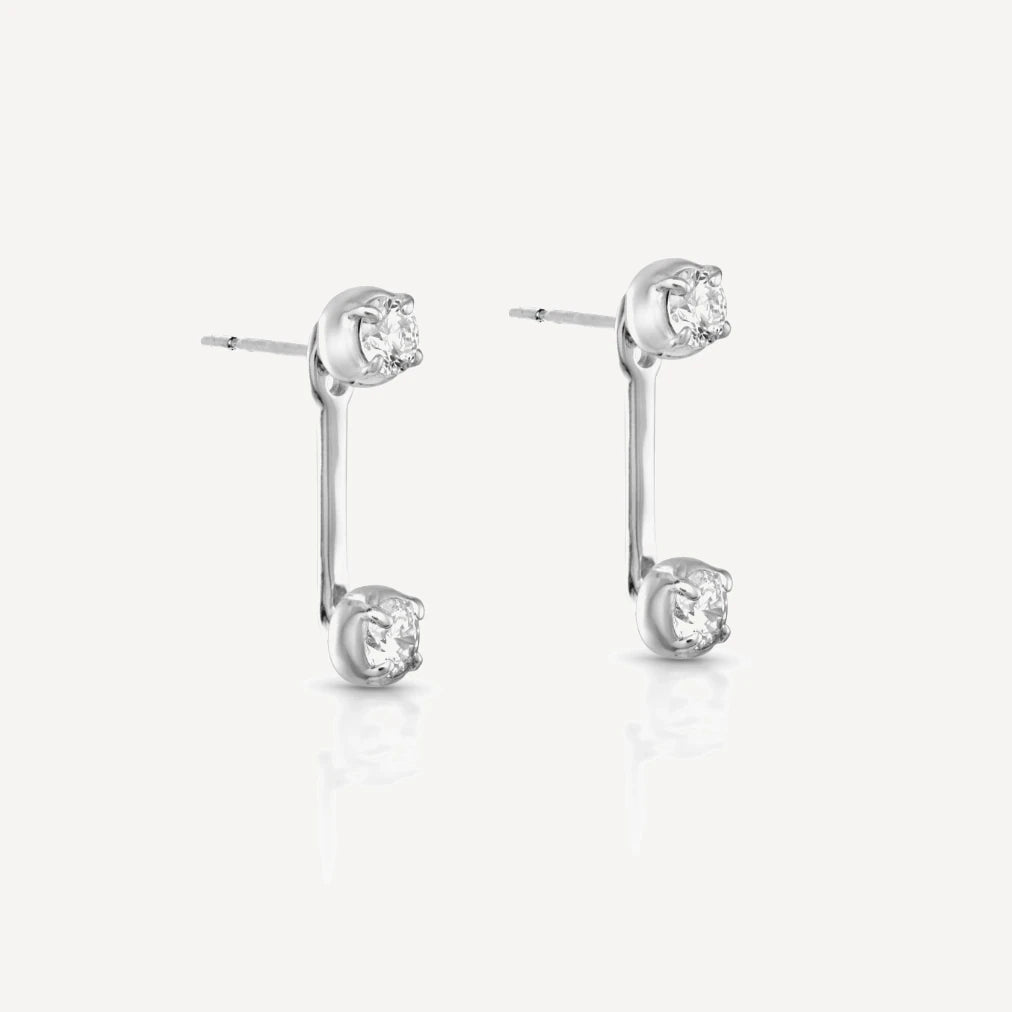 Sterling silver diamond stud earrings with matching adjustable diamond jacket featuring brilliant-cut diamonds in a modern ear jacket design on a soft beige background.