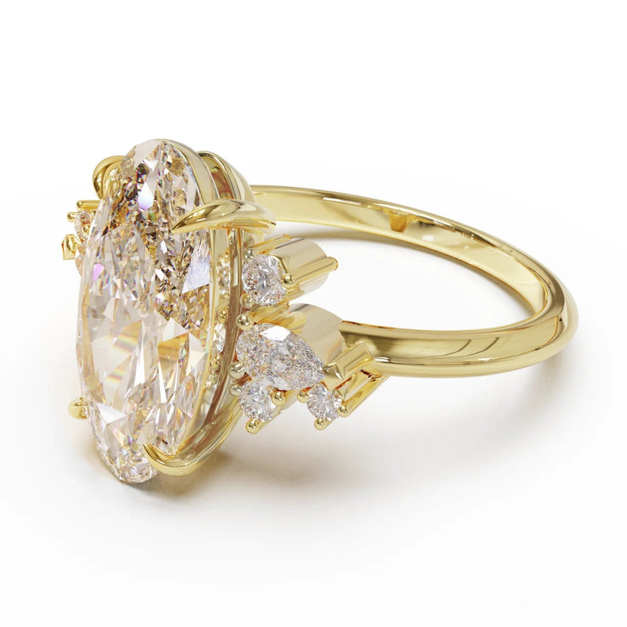 Gold ring with a large Moval Champagne diamond and smaller diamonds on a white background